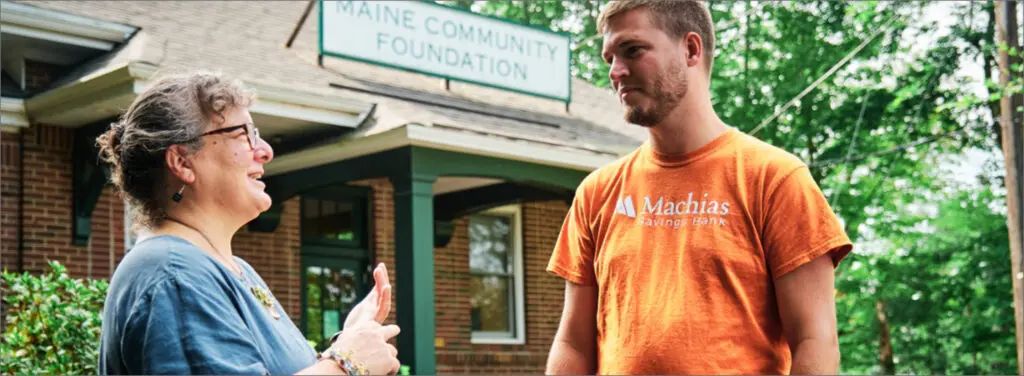 man having a conversation with a woman outside of building