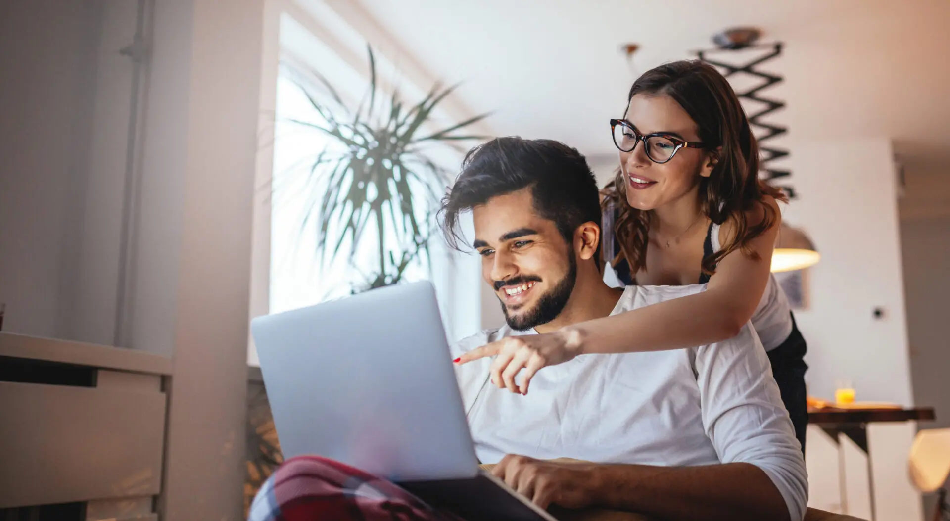 two people looking at a laptop