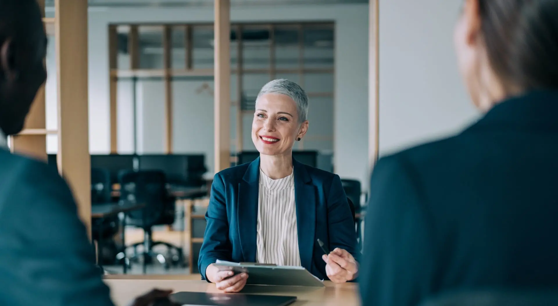 a person dressed in professional attire, having a meeting