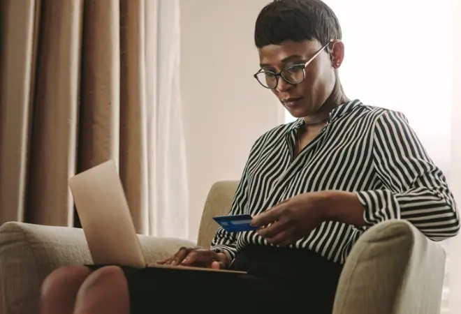 a woman on a laptop with credit card