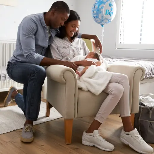 couple holding and looking at newborn baby