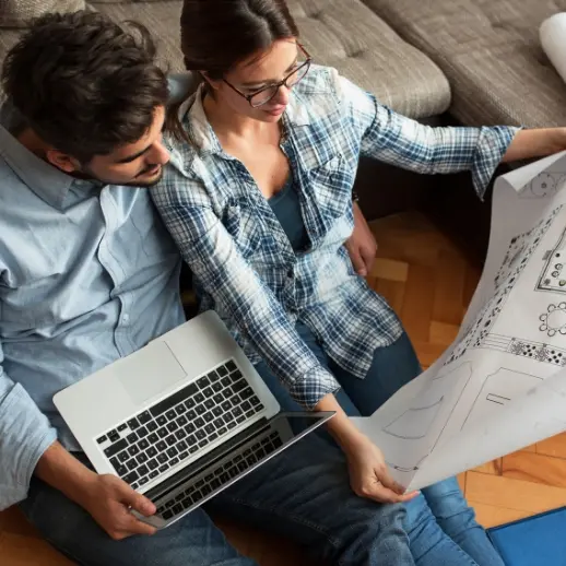 Two people looking at house design print