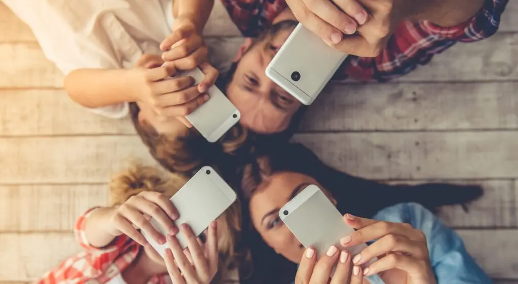 family looking at cell phones