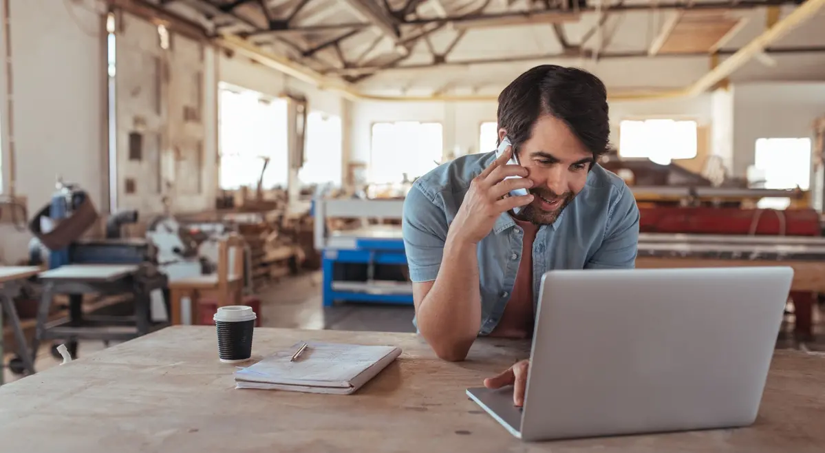 man in business on his phone and laptop