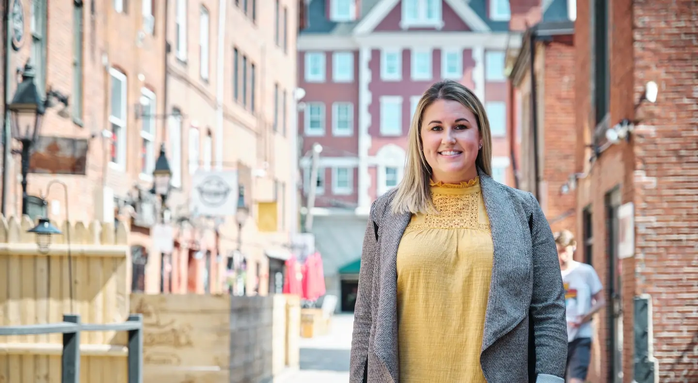 Woman standing in the street smiling