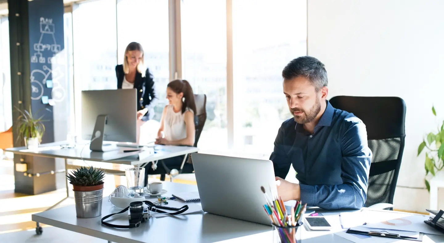 three people working in the office