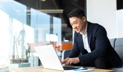 Business man doing work on laptop