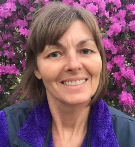 Woman in front of flowers