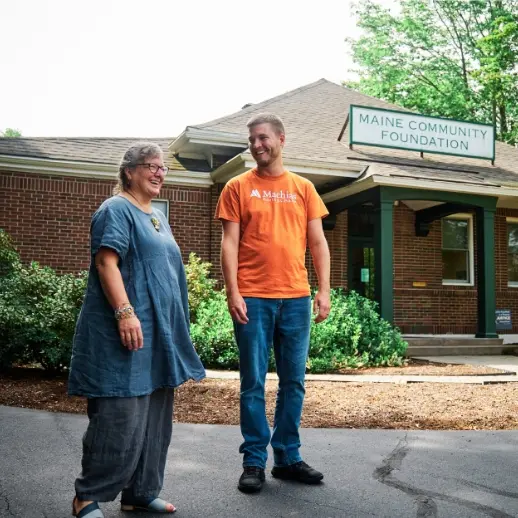 man and woman laughing and standing outside the Maine Community Foundation