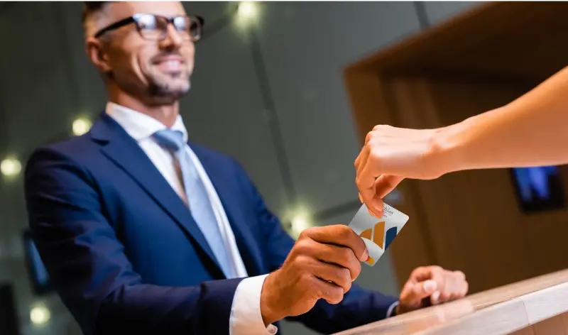 a man in a professional suit being handed a credit card