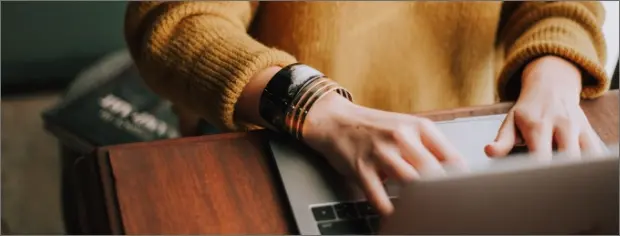 a person typing on a laptop computer