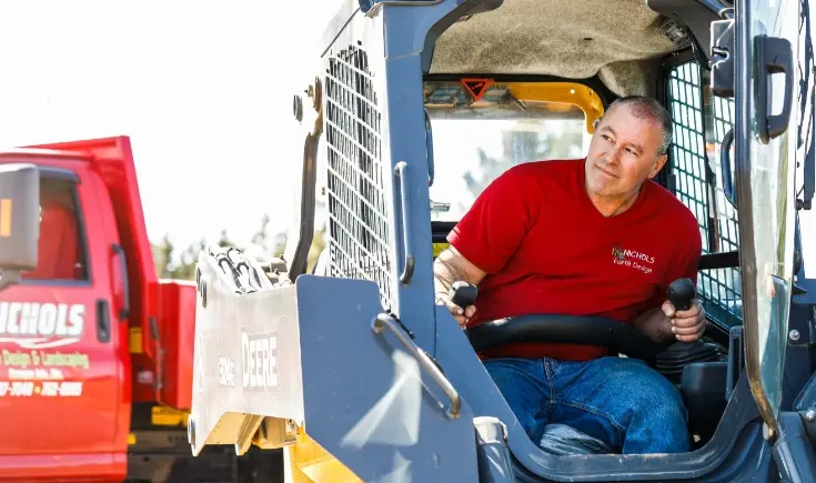 man operating john deere machinery