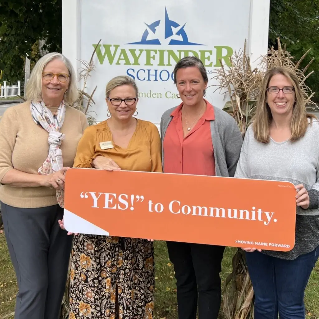 Four women holding Yes to Community sign