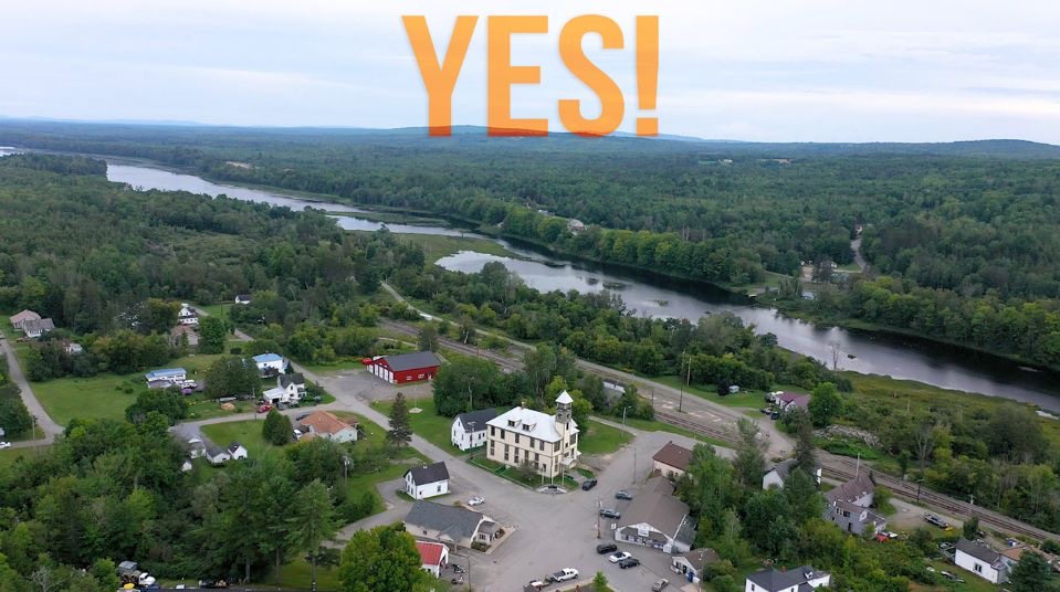 Overhead view of town with Yes in big orange letters