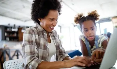 Mom and daughter looking at computer