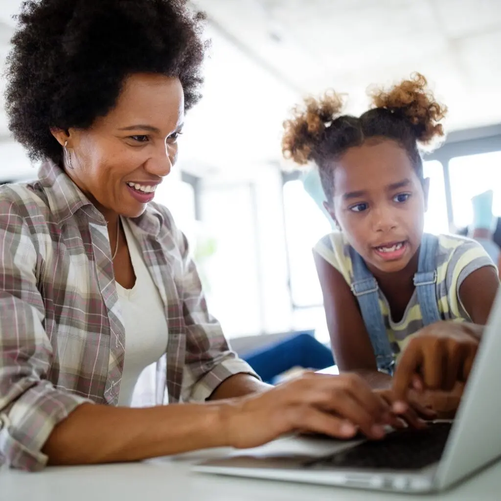 Mom and daughter looking at computer