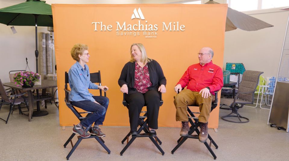 an interview with three people smiling and talking in directors chairs