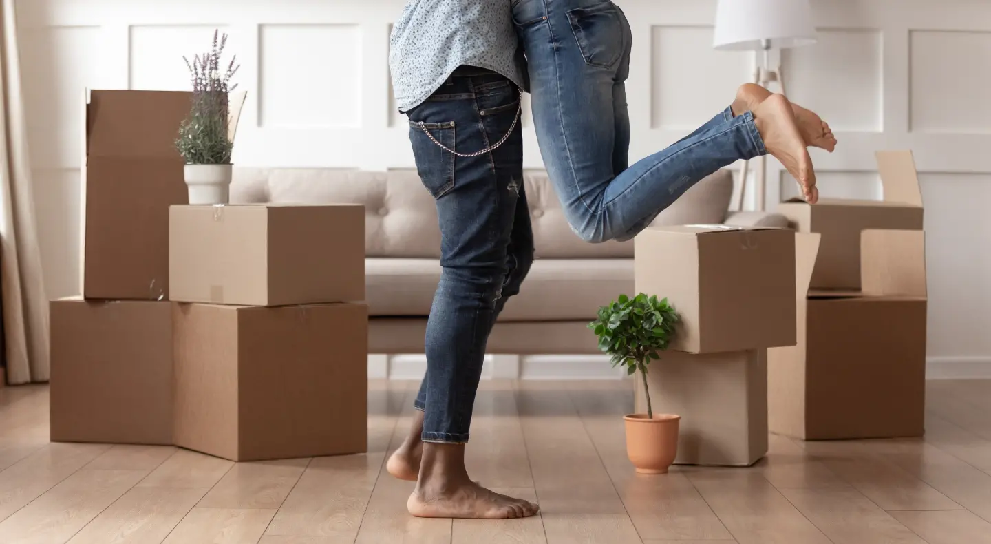a couple who just moved into a home with unpacked boxes in the background