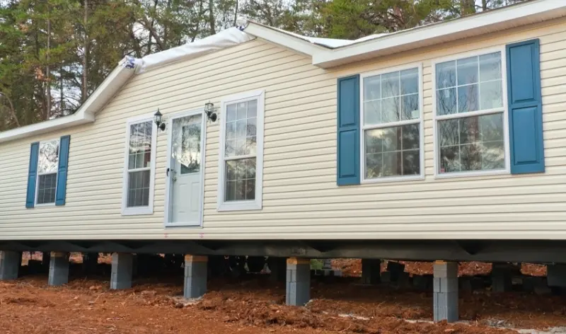 a creme-colored mobile home under construction