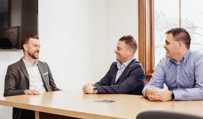 Employees sitting at a table smiling