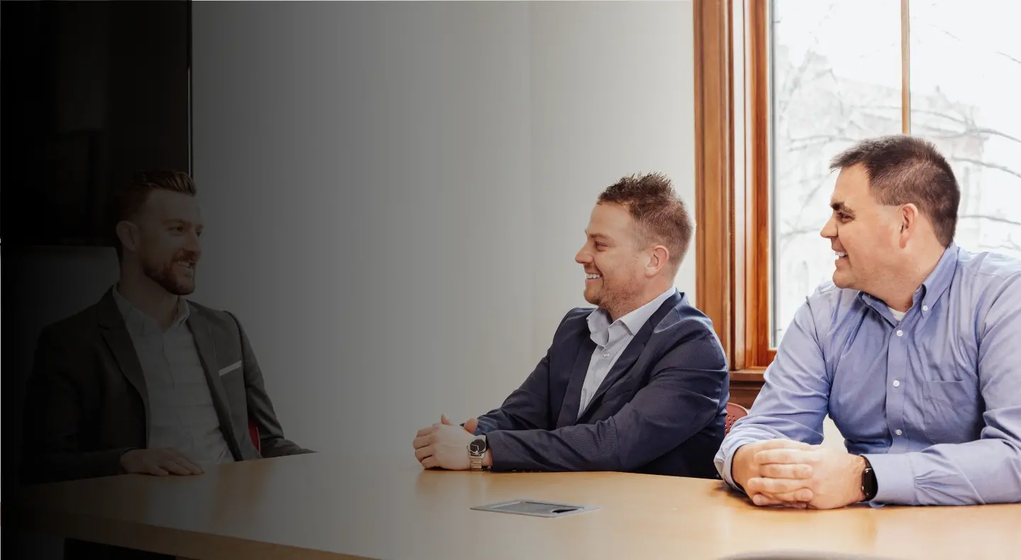 Employees sitting at a table smiling