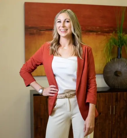 smiling woman in a bank, dressed in professional attire