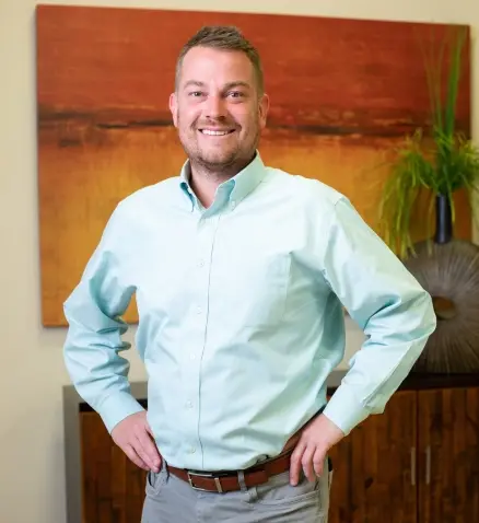 smiling man in a bank, dressed in professional attire