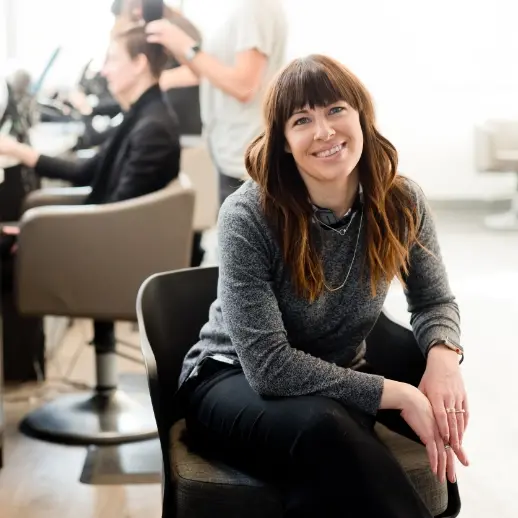 Woman smiling sitting in chair