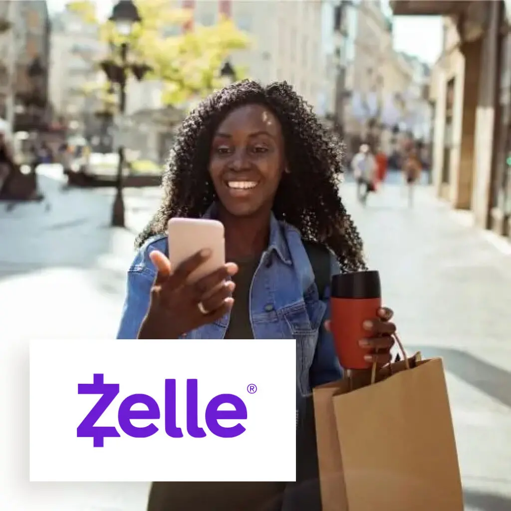 a person walking while holding a phone smiling, with emphasized text "zelle"