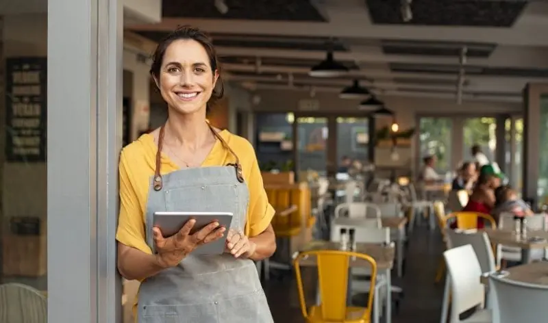 woman holding tablet in restaurant