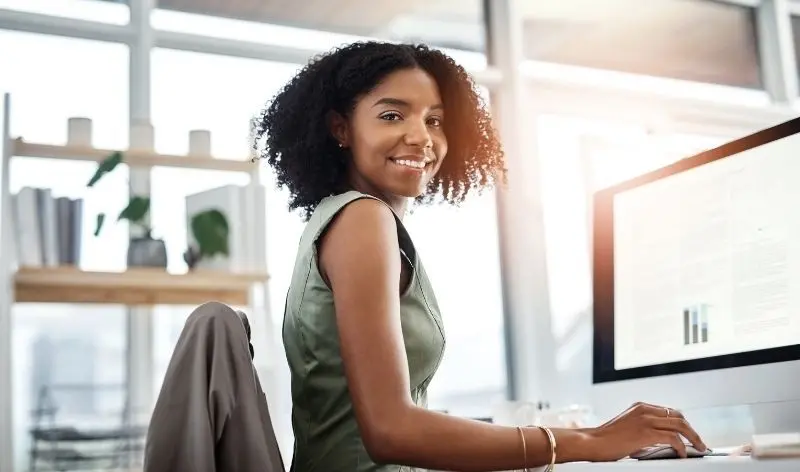 person working at a desk smiling