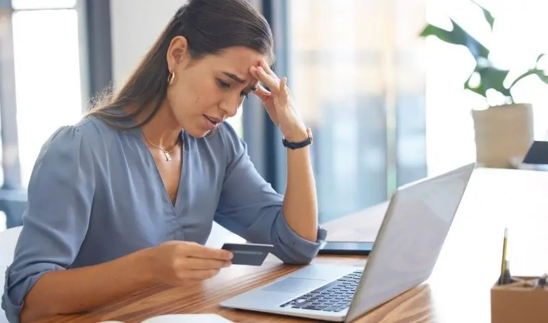 frustrated woman holding a card