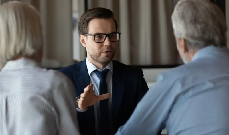 businessman talking with couple