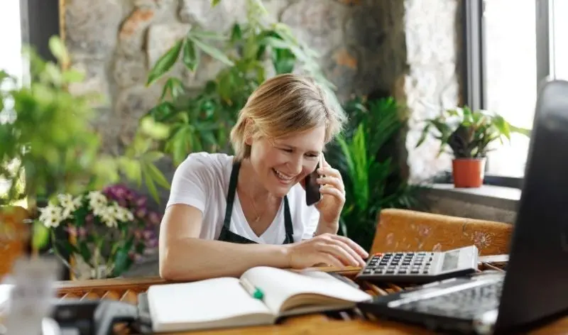 person on the phone looking at a notebook