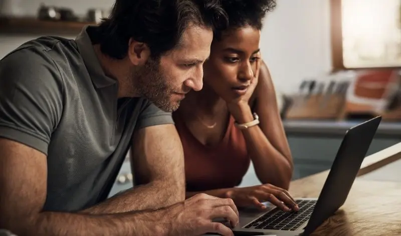 people looking at a laptop together