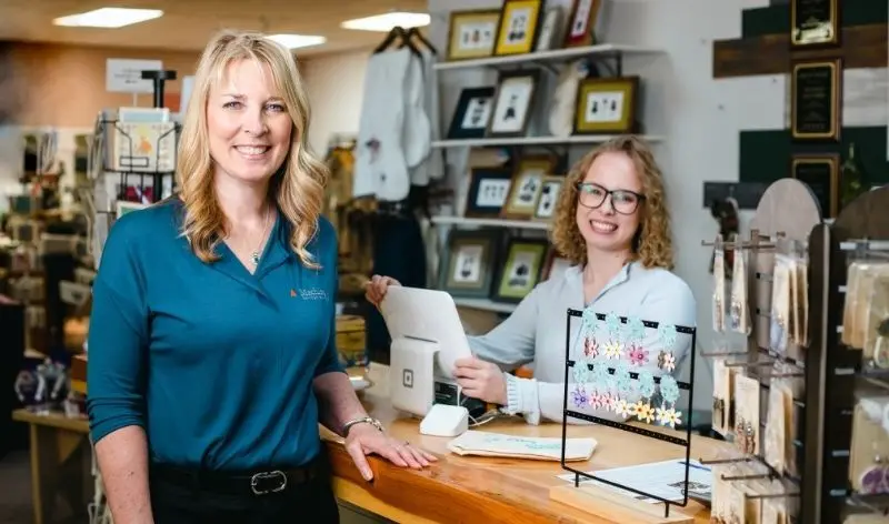 two people smiling in a shop