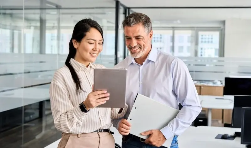 people discussing data on a tablet