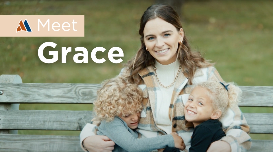 Grace sitting on a bench with two kids