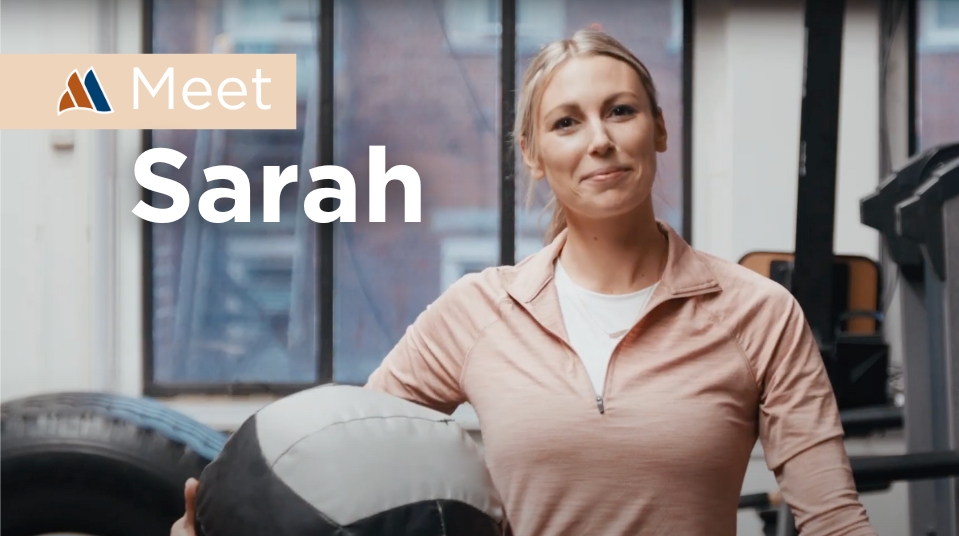 Sarah in a gym holding a medicine ball