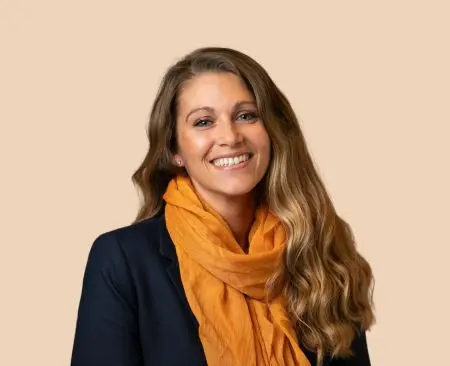 woman in black shirt and orange scarf smiling