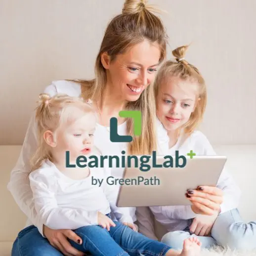 Mother with her two daughters looking at a tablet