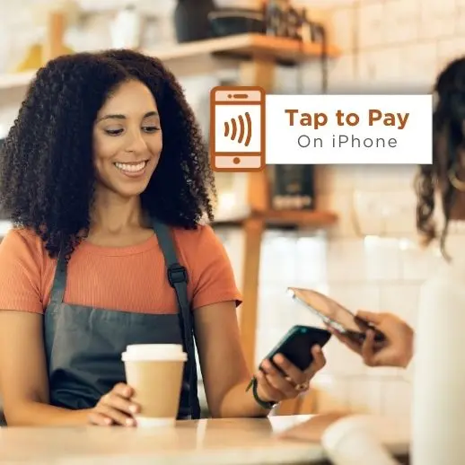 Woman using phone to pay for coffee.