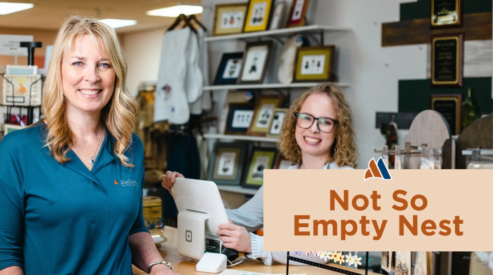 woman business owner behind counter at store with woman business banker